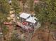 Charming home featuring a cozy back deck with a grill, seating, and outdoor rug at 26349 Pleasant Park Rd, Conifer, CO 80433