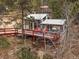 Charming home featuring a cozy back deck with a grill, seating, and outdoor rug at 26349 Pleasant Park Rd, Conifer, CO 80433