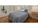 Comfortable bedroom featuring light walls and floors with two windows for natural light at 26349 Pleasant Park Rd, Conifer, CO 80433