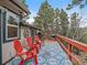 Inviting deck area featuring a grill and seating with scenic views of the surrounding landscape at 26349 Pleasant Park Rd, Conifer, CO 80433