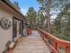 Charming patio featuring an area rug, seating and railing looking out to mature trees at 26349 Pleasant Park Rd, Conifer, CO 80433