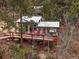 Charming exterior featuring a cozy deck with red chairs and peaceful mountain scenery at 26349 Pleasant Park Rd, Conifer, CO 80433