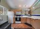 Traditional kitchen featuring wood cabinets, white countertops and backsplash with unique blue tile accents at 26349 Pleasant Park Rd, Conifer, CO 80433