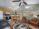 Well lit kitchen with wood burning stove, hardwood floors, cabinets, and a view at 26349 Pleasant Park Rd, Conifer, CO 80433
