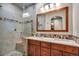 Beautiful bathroom featuring a double vanity, sleek countertops, mosaic tile, and a glass-enclosed shower at 9590 S Warhawk Rd, Conifer, CO 80433