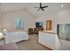 Bright, airy bedroom with vaulted ceiling, fan, large window, and sitting area at 9590 S Warhawk Rd, Conifer, CO 80433