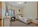 Comfortable bedroom with a window, accent lighting, and a cozy atmosphere at 9590 S Warhawk Rd, Conifer, CO 80433