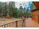 Wood deck showcasing views of the surrounding forest and a wood railing at 9590 S Warhawk Rd, Conifer, CO 80433