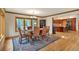 A formal dining room with wood floors, large windows, and a decorative rug at 9590 S Warhawk Rd, Conifer, CO 80433