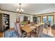 An elegant dining room with wood table, chairs, and a view to the outdoor patio at 9590 S Warhawk Rd, Conifer, CO 80433
