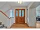 Elegant entryway with hardwood floors, a decorative glass door, and stairs leading to the upper level at 9590 S Warhawk Rd, Conifer, CO 80433