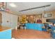 Spacious garage featuring a workbench, tool storage, heater, desk and ample workspace at 9590 S Warhawk Rd, Conifer, CO 80433