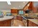 A gourmet kitchen with wood cabinets, stainless appliances, and a stone backsplash at 9590 S Warhawk Rd, Conifer, CO 80433