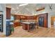 Bright kitchen with a large island, wood cabinets, and modern appliances, perfect for cooking and entertaining at 9590 S Warhawk Rd, Conifer, CO 80433