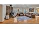 Cozy living room with wood floors, comfortable seating, and a stone fireplace with a wood-burning stove at 9590 S Warhawk Rd, Conifer, CO 80433