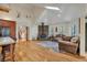 Bright living space with a stone fireplace, wood floors, comfortable seating, and an open layout at 9590 S Warhawk Rd, Conifer, CO 80433