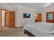 A spacious main bedroom features neutral colors and wood trim at 9590 S Warhawk Rd, Conifer, CO 80433