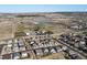 Aerial view showcasing the residential neighborhood, surrounding landscape, and recreational fields at 17880 Weymouth Ave, Parker, CO 80134