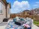 Outdoor patio with lounge furniture, a fire pit, manicured lawn, and privacy fence at 17880 Weymouth Ave, Parker, CO 80134