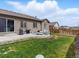 Home's outdoor patio has seating, a grill, and a manicured lawn with a privacy fence at 17880 Weymouth Ave, Parker, CO 80134