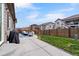 Home's covered patio is next to a fenced yard with mature landscaping and grass at 17880 Weymouth Ave, Parker, CO 80134