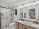 Modern bathroom featuring a double sink vanity, marble walk-in shower, and modern fixtures at 17880 Weymouth Ave, Parker, CO 80134