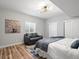 Bright bedroom features hardwood floors, ensuite bathroom, and a cozy sitting area at 17880 Weymouth Ave, Parker, CO 80134