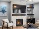 Cozy living room showcasing a stone fireplace, hardwood floors, with neutral toned furniture and décor at 17880 Weymouth Ave, Parker, CO 80134