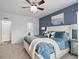 Main bedroom with plush carpet, blue accent wall, white furniture, and bright natural light at 17880 Weymouth Ave, Parker, CO 80134