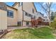 Home's backyard features a blend of grass and rock landscaping with access to an upper-level deck at 12551 W 84Th Cir, Arvada, CO 80005
