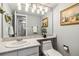 Clean bathroom with a modern countertop, framed art, and contemporary lighting at 12551 W 84Th Cir, Arvada, CO 80005