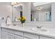 A double vanity in a light gray bathroom, featuring a white countertop and backsplash, as well as recessed lighting at 12551 W 84Th Cir, Arvada, CO 80005
