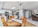 Inviting dining area with wood table, chandelier, and bright white kitchen with stainless steel appliances at 12551 W 84Th Cir, Arvada, CO 80005
