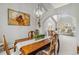Bright dining room with wooden table under modern chandelier, adjacent to the living room at 12551 W 84Th Cir, Arvada, CO 80005