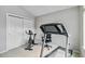 Home exercise room featuring a treadmill and spin bike, and white carpeting at 12551 W 84Th Cir, Arvada, CO 80005