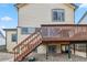 Back of home featuring upper level deck with stairs to the spacious yard at 12551 W 84Th Cir, Arvada, CO 80005