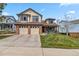 Charming two-story home with a well-manicured lawn and a two-car garage at 12551 W 84Th Cir, Arvada, CO 80005