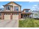 Charming two-story home with a well-manicured lawn and a two-car garage at 12551 W 84Th Cir, Arvada, CO 80005
