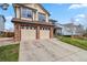 Charming two-story home with a well-manicured lawn and a two-car garage at 12551 W 84Th Cir, Arvada, CO 80005