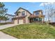 Charming two-story home with a well-manicured lawn and a two-car garage at 12551 W 84Th Cir, Arvada, CO 80005