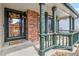 Inviting front porch with brick accents, decorative columns, and a charming welcome mat at 12551 W 84Th Cir, Arvada, CO 80005