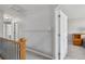 Upstairs hallway with an opening to a bedroom with carpet, ceiling fan and a window at 12551 W 84Th Cir, Arvada, CO 80005