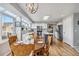 Modern kitchen and breakfast nook featuring white cabinets, a center island, and stainless appliances at 12551 W 84Th Cir, Arvada, CO 80005