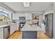 Modern kitchen with stainless steel appliances, white cabinetry, and large island with quartz countertops at 12551 W 84Th Cir, Arvada, CO 80005