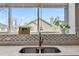 Close up of kitchen sink with a nice view of the backyard from the large bright window at 12551 W 84Th Cir, Arvada, CO 80005
