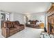 Inviting living room showcasing a cozy fireplace and comfortable seating arrangement at 12551 W 84Th Cir, Arvada, CO 80005