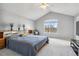 Bright main bedroom features vaulted ceilings, large windows, and comfortable furnishings at 12551 W 84Th Cir, Arvada, CO 80005
