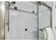 Close up of a renovated shower with subway tile, chrome shower head and glass door at 12551 W 84Th Cir, Arvada, CO 80005