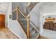Carpeted staircase with wood and wrought iron railing leading to the upper level at 12551 W 84Th Cir, Arvada, CO 80005