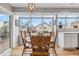 Bright sunroom with a dining table, large windows, and view of the outside yard at 12551 W 84Th Cir, Arvada, CO 80005